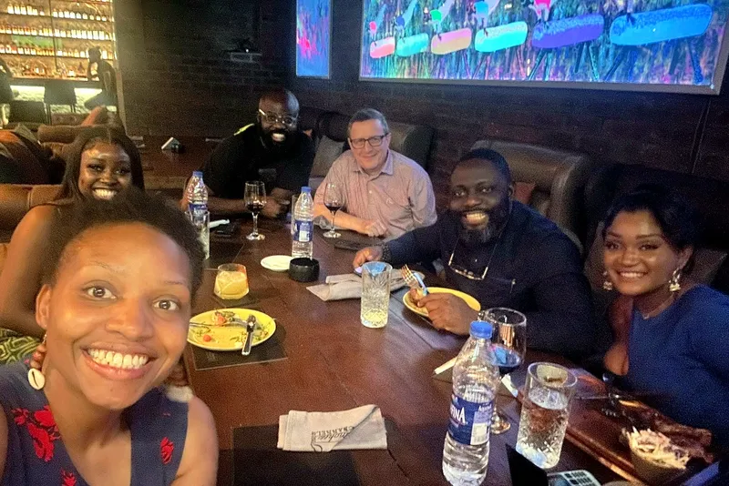 Speakers and leaders smiling together over dinner at the pre-event mixer